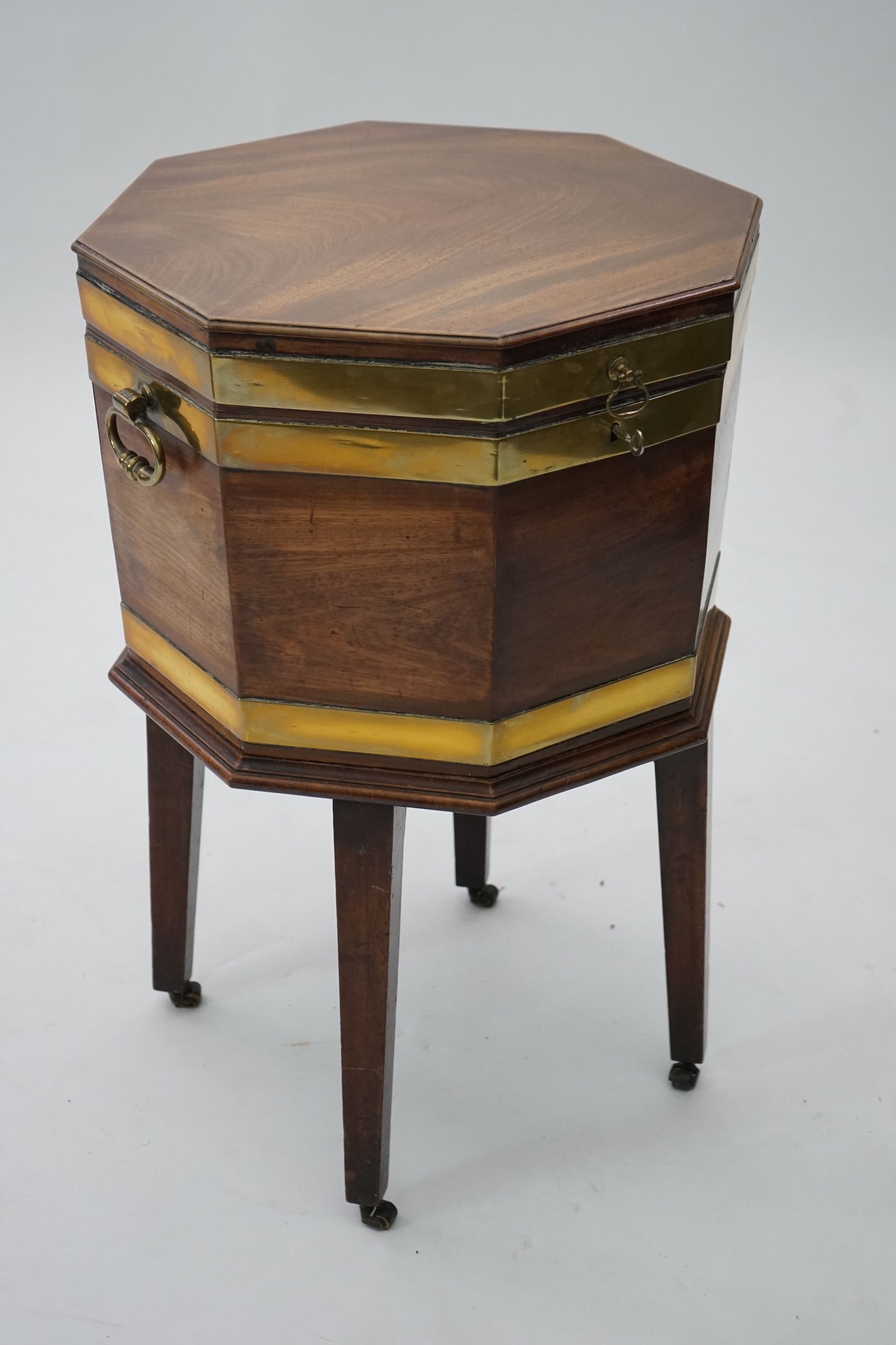 A George III mahogany triple brass banded octagonal cellarette